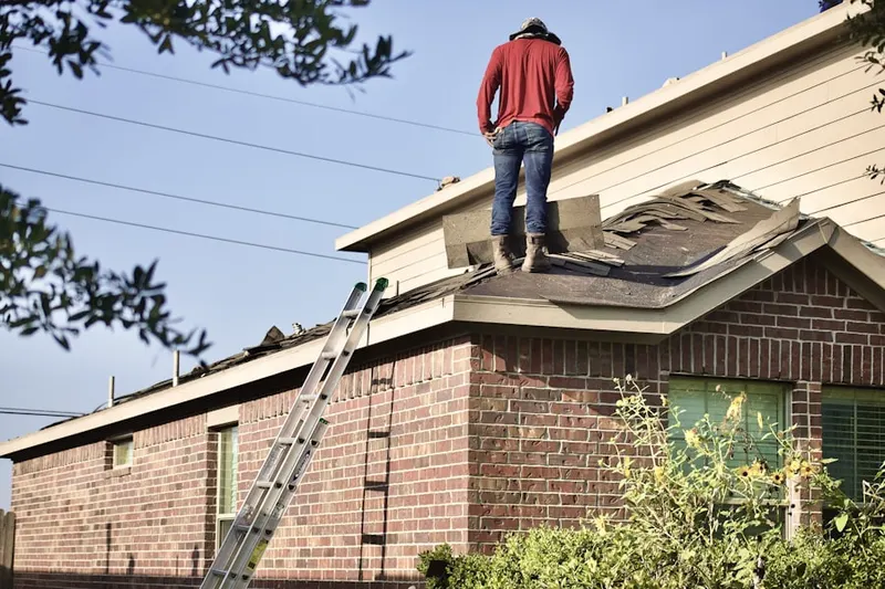 Professional roofer working on a residential roof in Sunaire